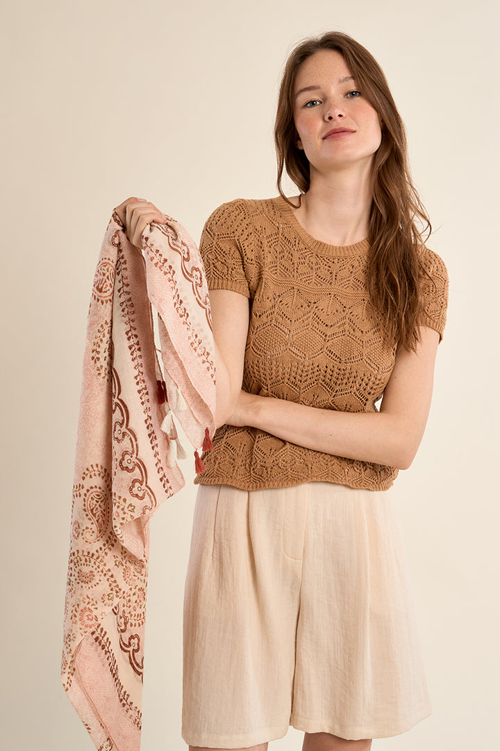 Primrose Paisley scarf by Molly Bracken featuring a soft pink paisley pattern and soft fabric, displayed in a stylish fashion setting.