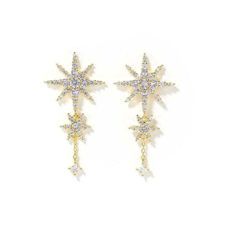 Gold star-shaped earrings with clear stones on a white background