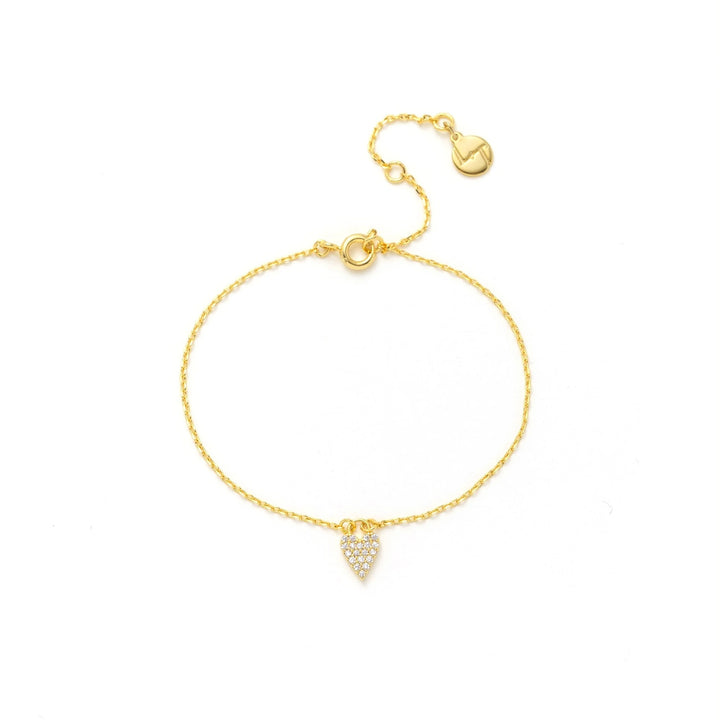 Gold bracelet with a small heart-shaped pendant on a white background