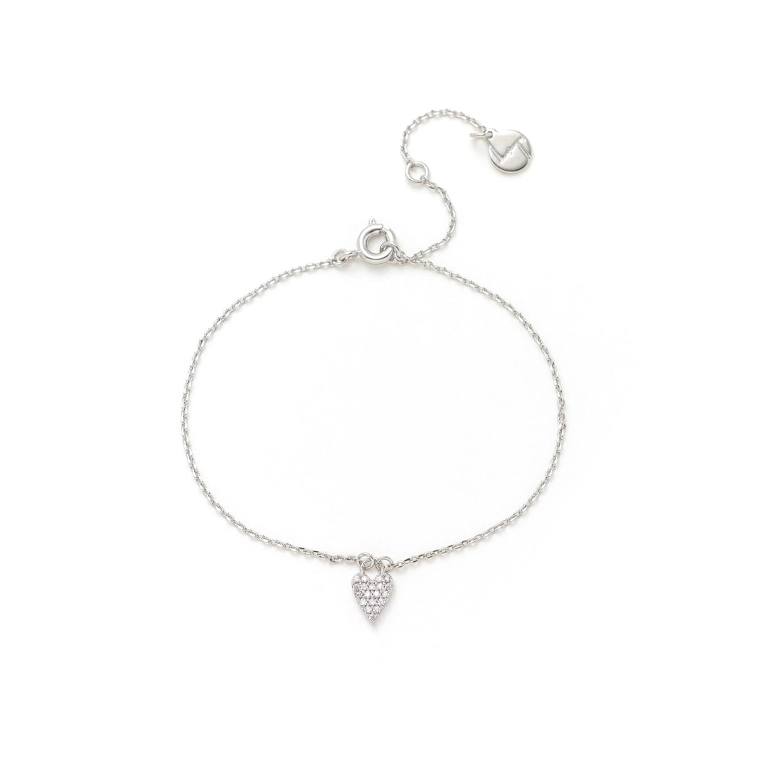 Silver bracelet with a heart-shaped charm on a white background