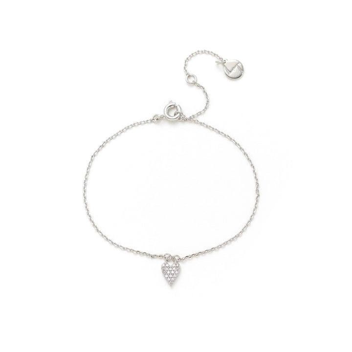 Silver bracelet with a heart-shaped charm on a white background