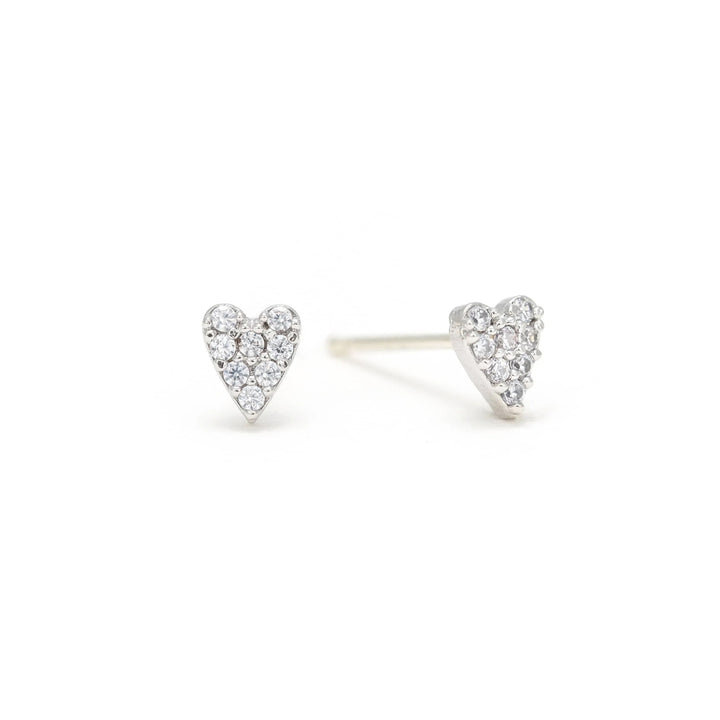 Heart-shaped diamond earrings on a white background