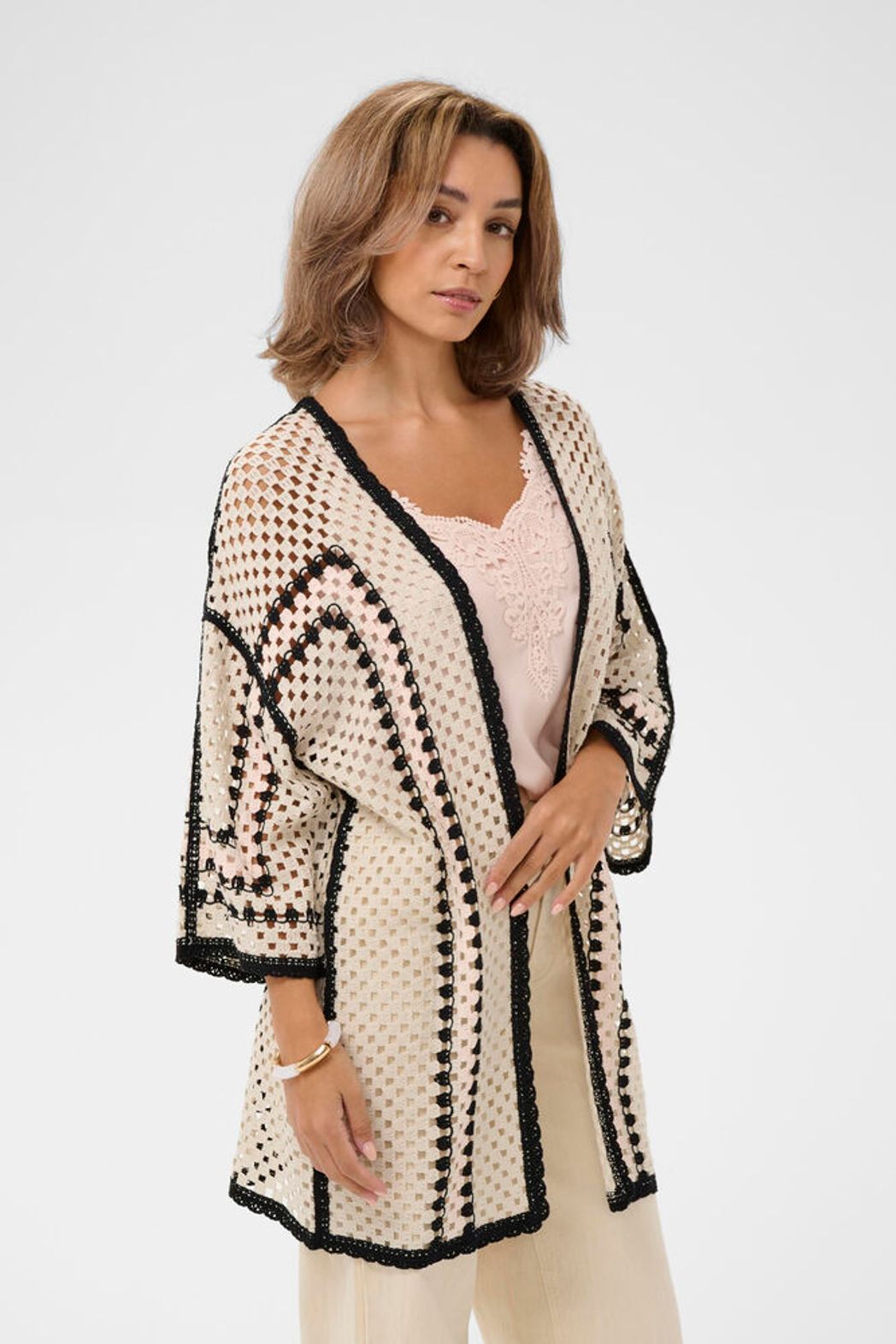 Cream Free Fly crochet kimono featuring open-knit design, lightweight fabric, and relaxed fit, perfect for layering and boho style.