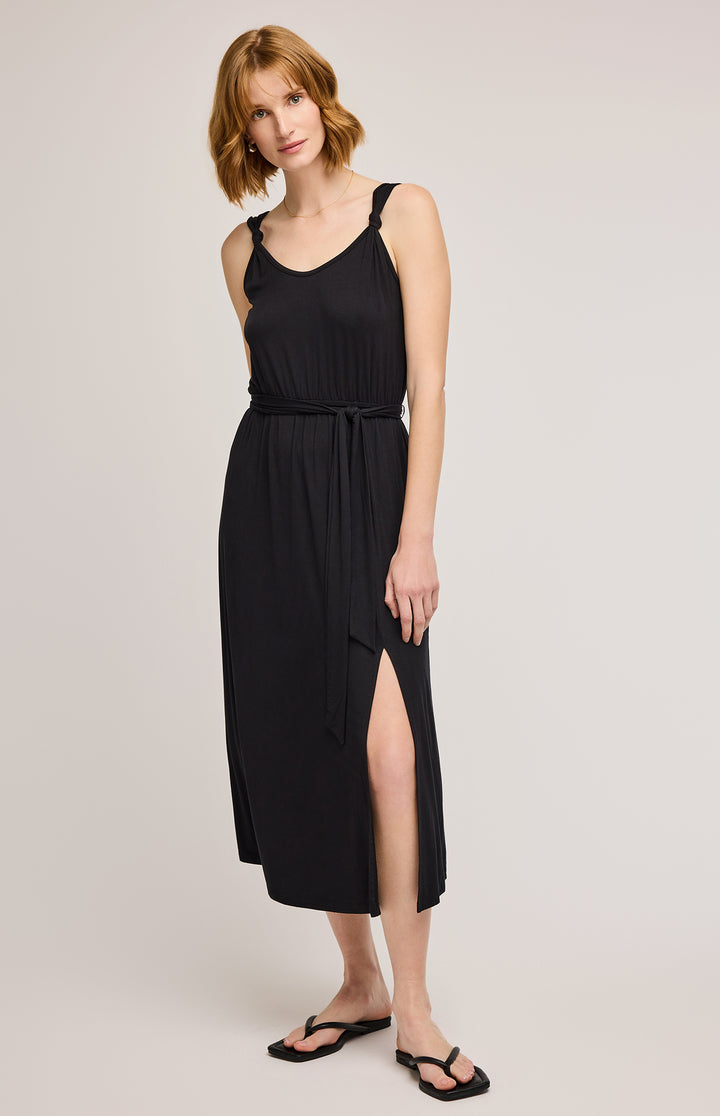 Women’s black jersey dress with belted waist  and slit on midi length skirt