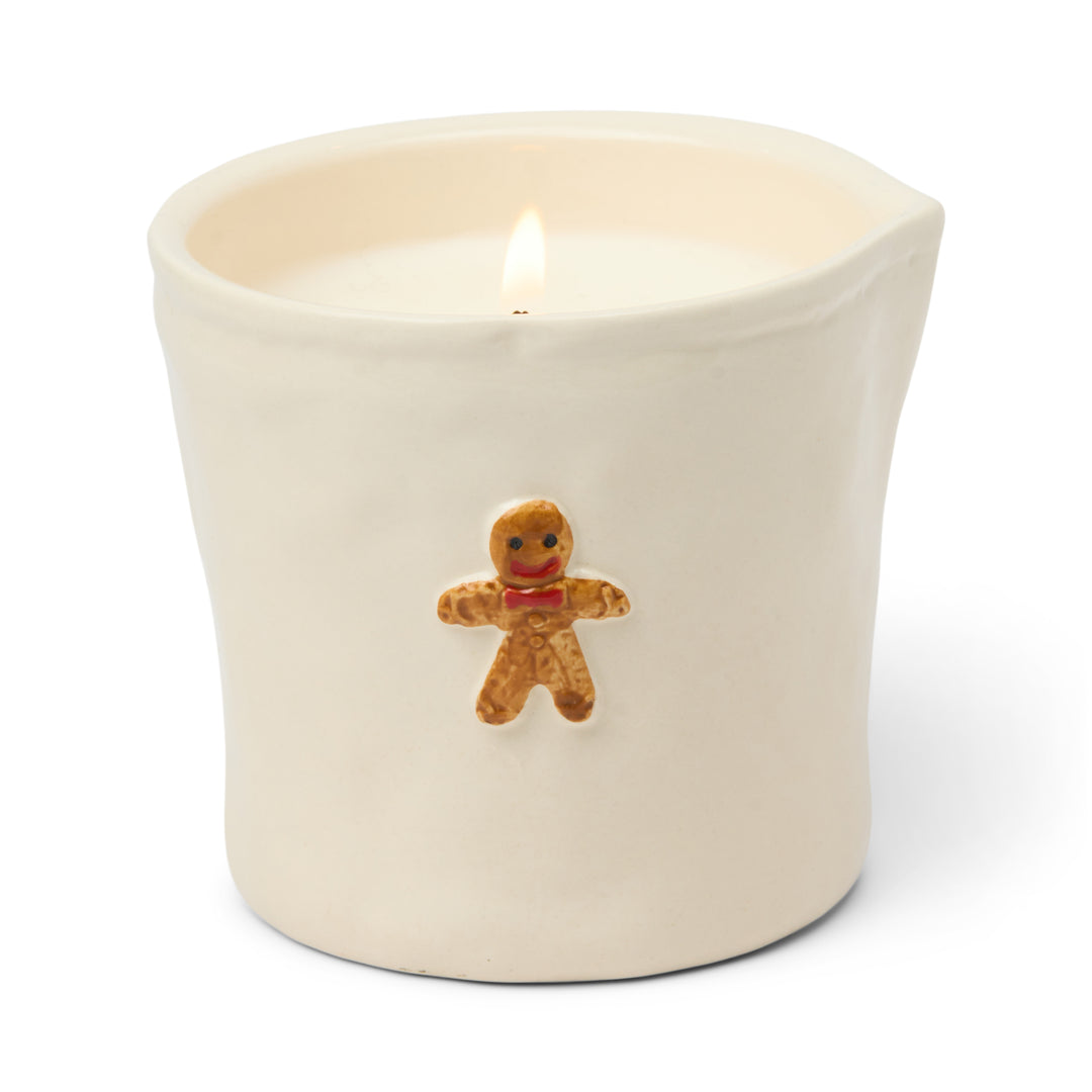 Candle in a white container with a gingerbread man design