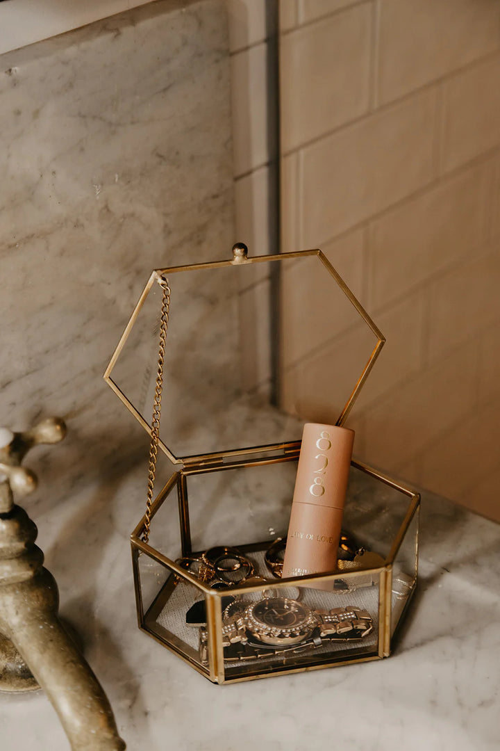 Lady of Love solid perfume by 828 Aroma Inc. displayed in a sleek container, featuring elegant packaging and a smooth, creamy texture.