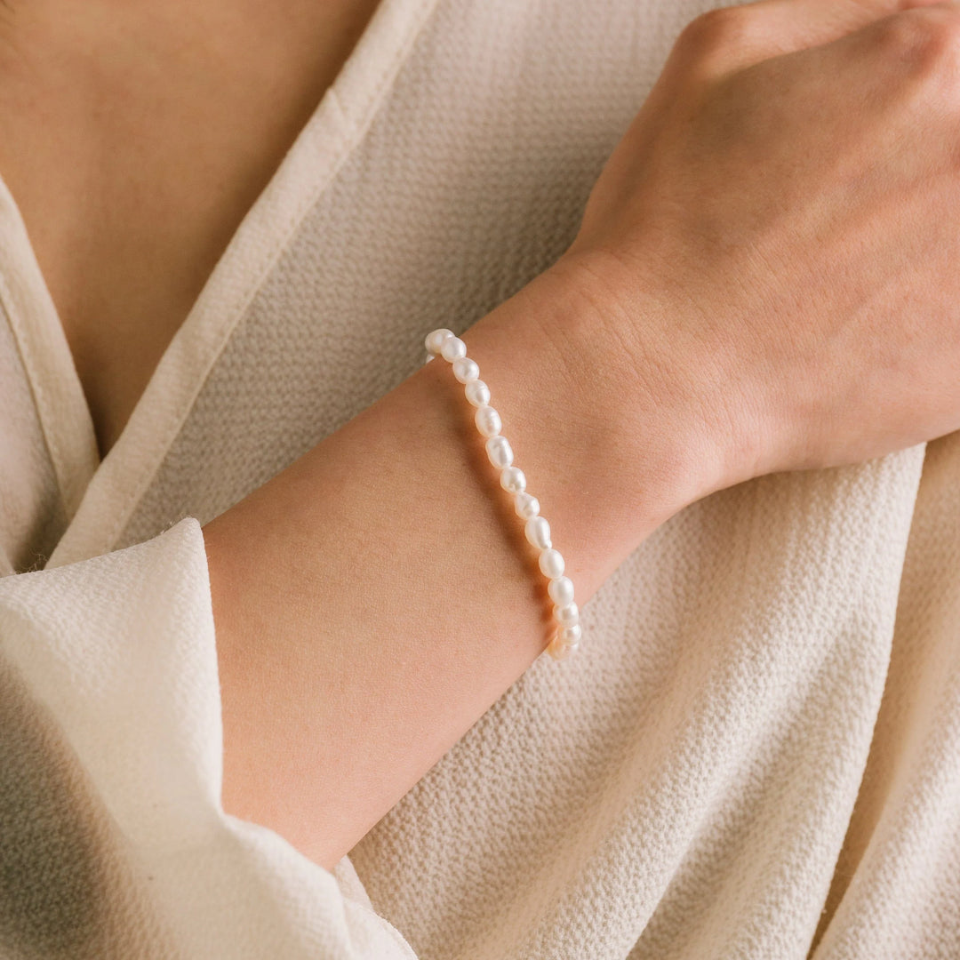 Lover's Tempo Isola Pearl Bracelet featuring elegant white pearls on a delicate gold chain.