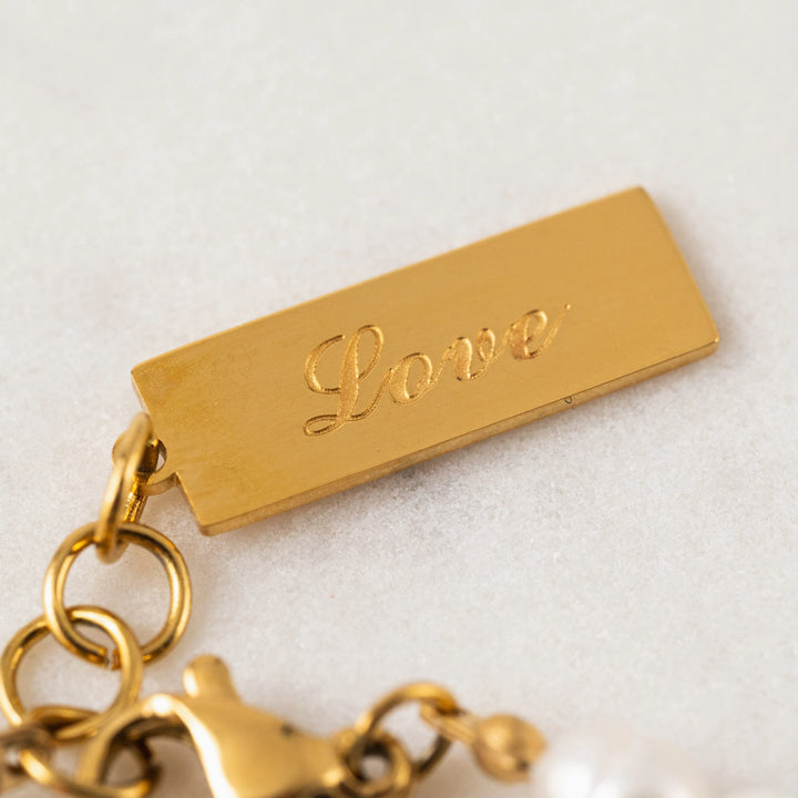 Lover's Tempo Isola Pearl Bracelet featuring elegant white pearls on a delicate gold chain.