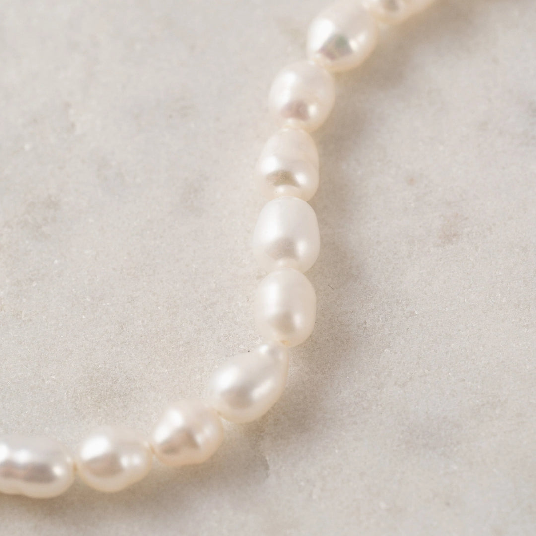 Lover's Tempo Isola Pearl Bracelet featuring elegant white pearl beads and a delicate gold clasp.