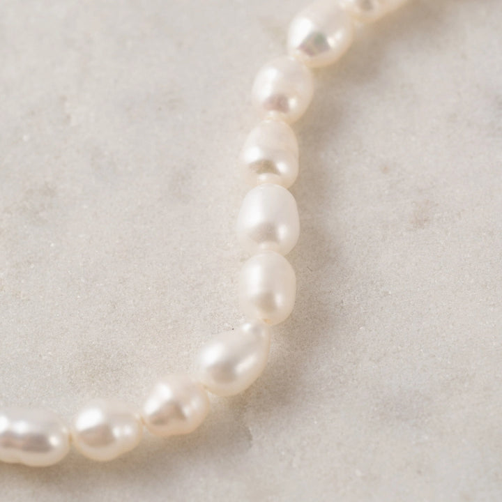 Lover's Tempo Isola Pearl Bracelet featuring elegant white pearl beads and a delicate gold clasp.