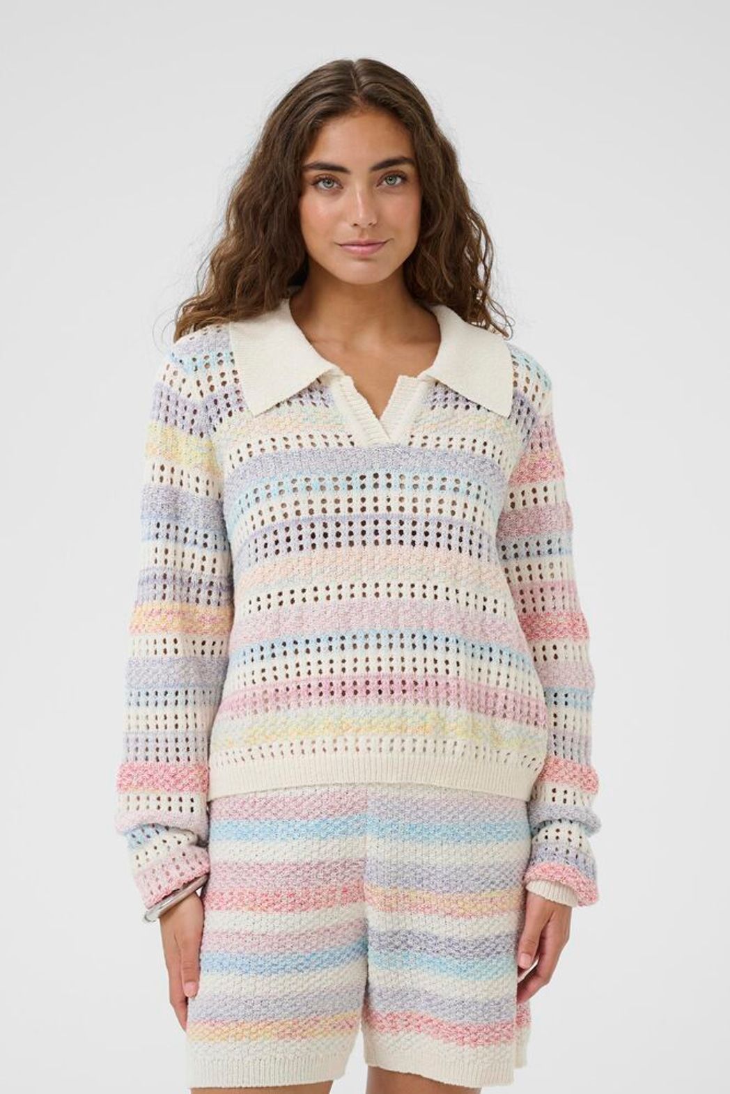 Culture Juana Knit Polo Sweater featuring a classic collar, button detail, and cozy knit stripe fabric in light pastel tones.