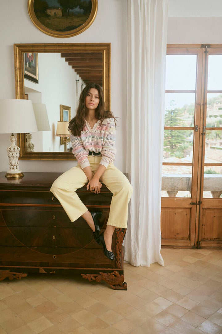 Culture Juana Knit Polo Sweater displayed on a model, featuring a classic collar, textured open knit fabric, and long sleeves.
