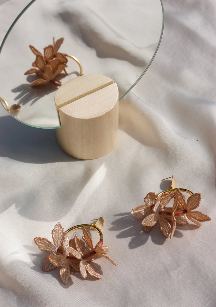 Ilk Jewelry Kui Lei Flower Hoop Earring featuring a delicate floral design in vintage lace and in gold-tone metal on a hoop style earring