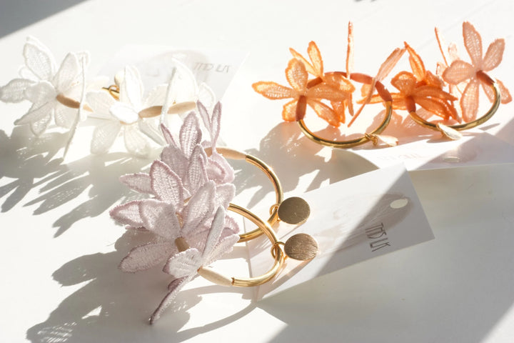 Ilk Jewelry Kui Lei Flower Hoop Earring featuring delicate floral design in vintage lace and gold-tone hoop for elegant style.