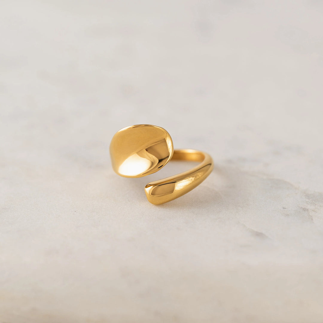 Gold ring on a light gray background