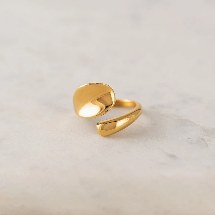 Gold ring on a light gray background
