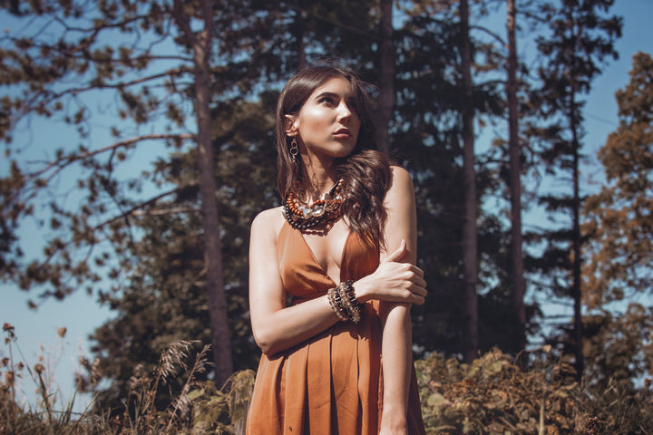 Lofttan Nay Palm Wood Necklace featuring a natural wooden pendant on a cord, showcasing unique grain and craftsmanship.