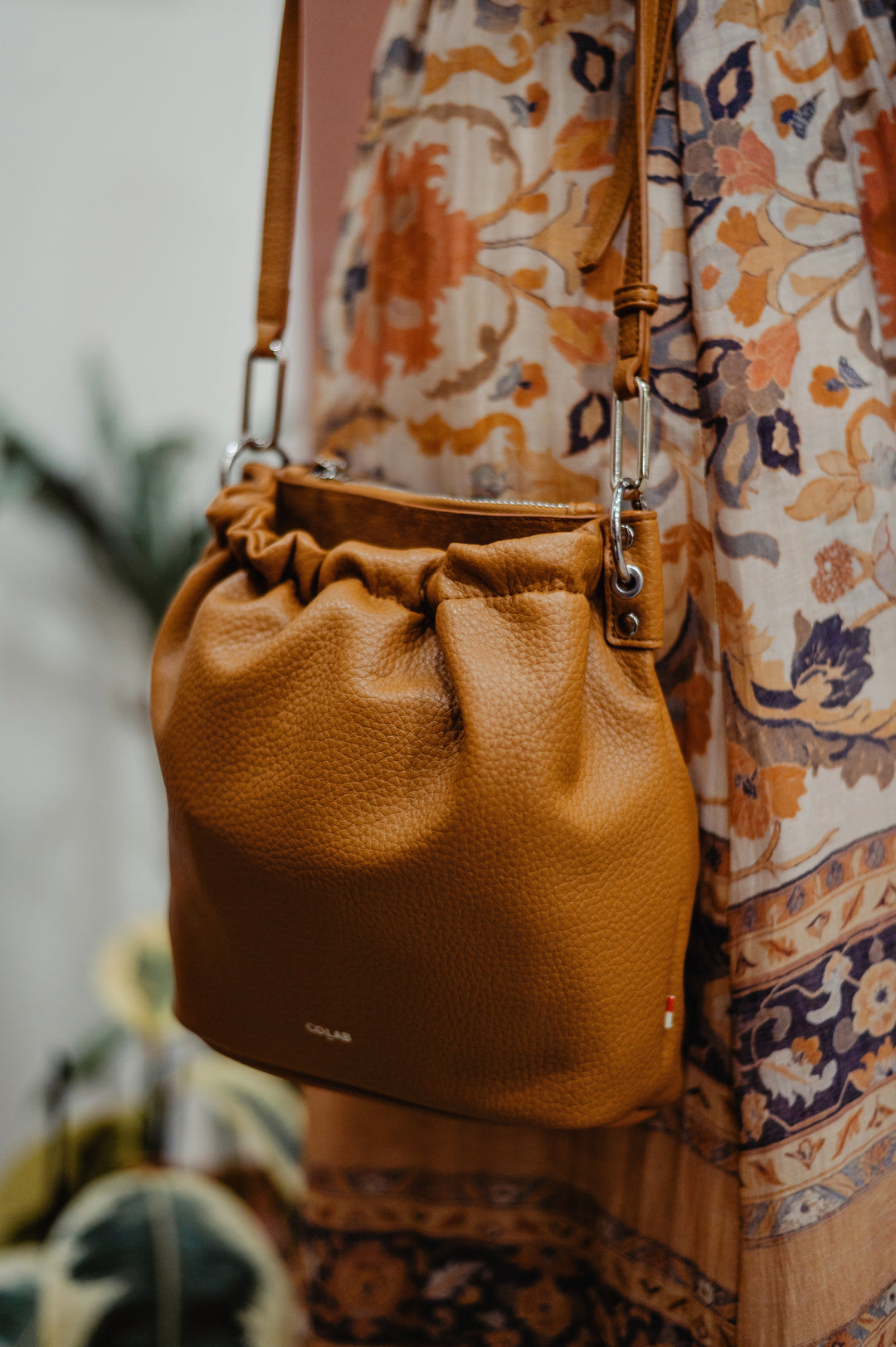 Colab Florence Bucket Bag with adjustable strap and stylish design, featuring a spacious interior and contemporary fashion appeal.