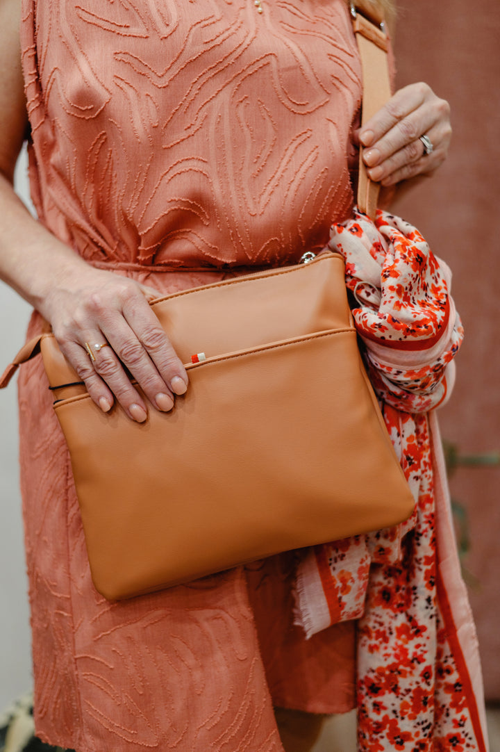 Colab Arquette Crossbody Bag with adjustable strap and stylish design, featuring a sleek silhouette and versatile storage options.
