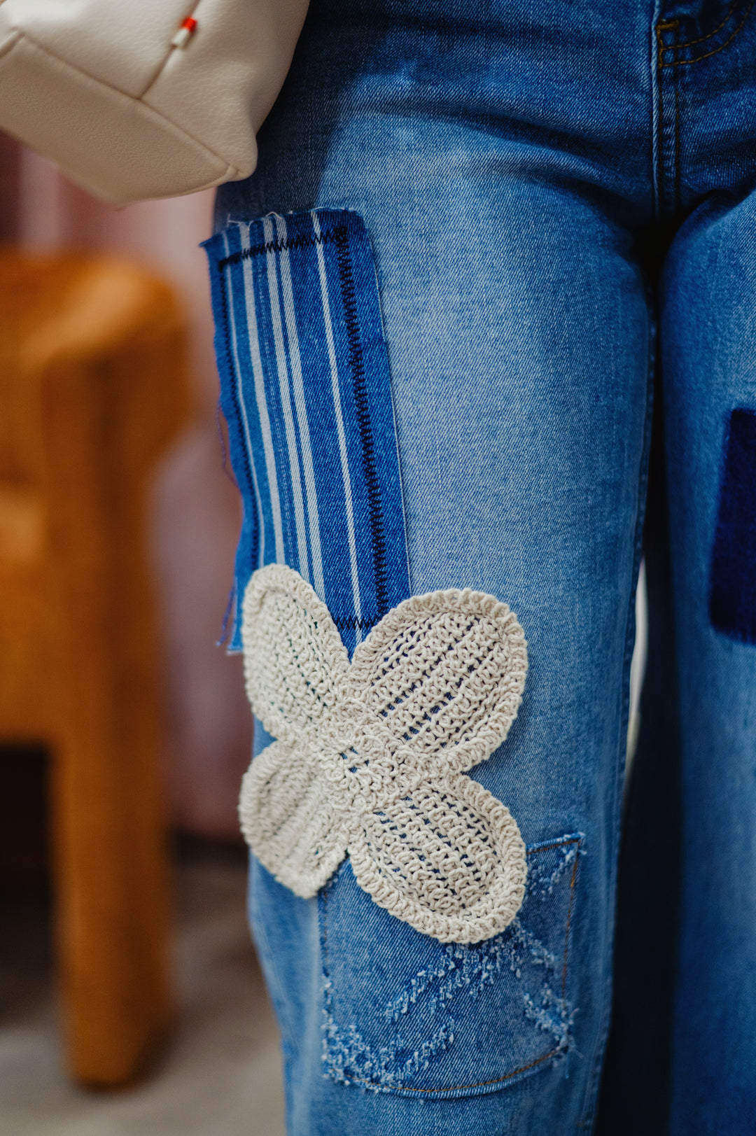 Desigual Daisy Mae Crop Jean showing high-waisted denim jeans with a relaxed fit and cropped length, featuring faded blue wash and  retro inspired patchwork detail..