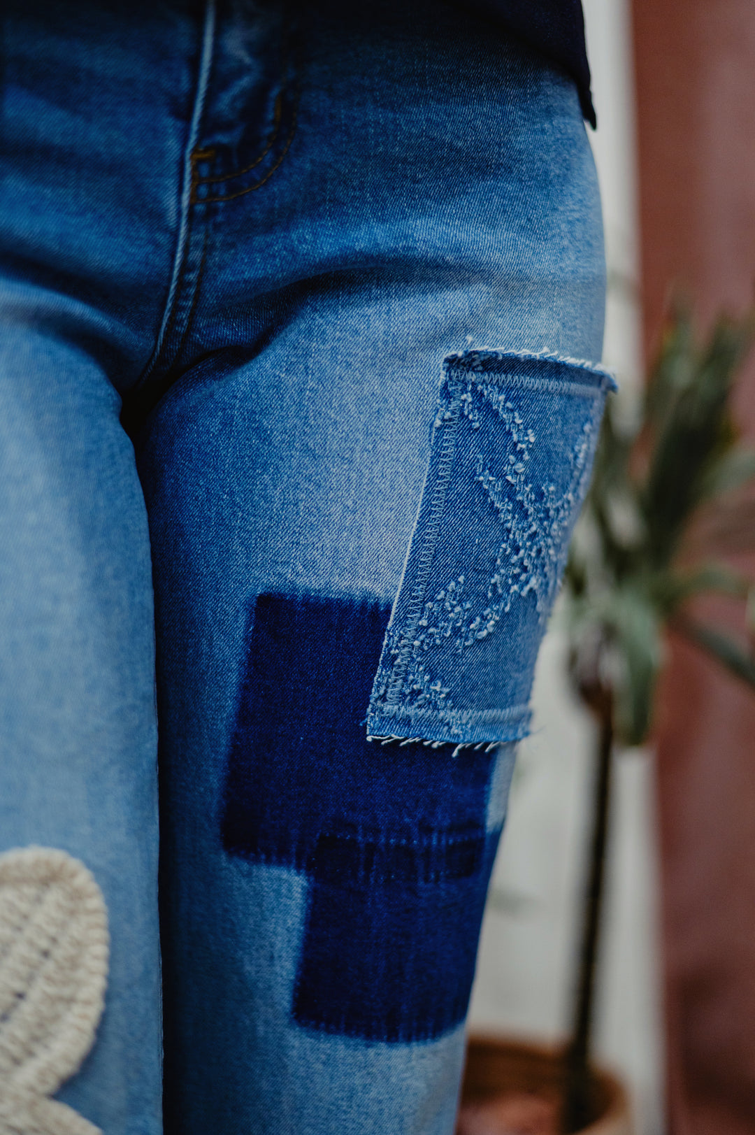 Desigual Daisy Mae Crop Jean featuring distressed denim, high-waisted fit,  retro inspired patchwork detail, and classic five-pocket design on light blue denim.