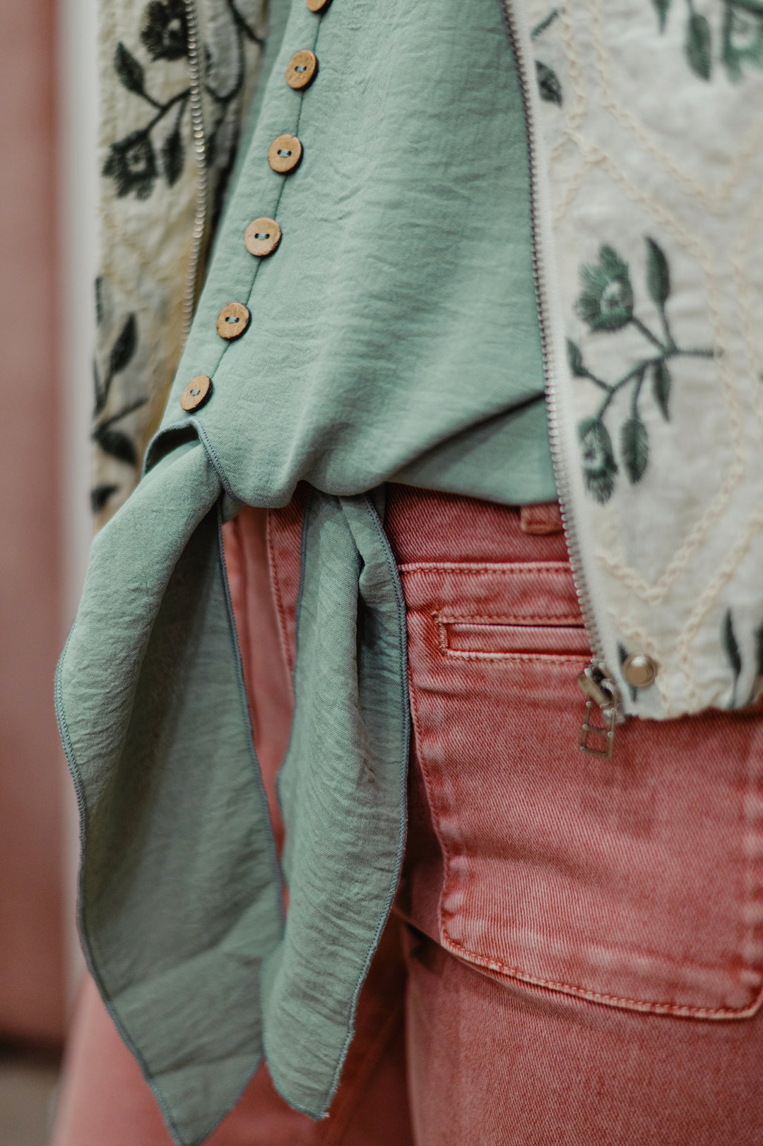 Molly Bracken Maren sleeveless tank top with a stylish tie-waist design, button detail lightweight sage green fabric, perfect for casual or summer wear.