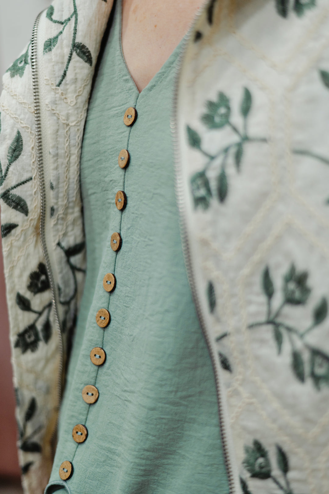 Molly Bracken Maren tie-waist sleeveless blouse with tank top style, featuring a stylish design, button detail and lightweight sage green fabric.
