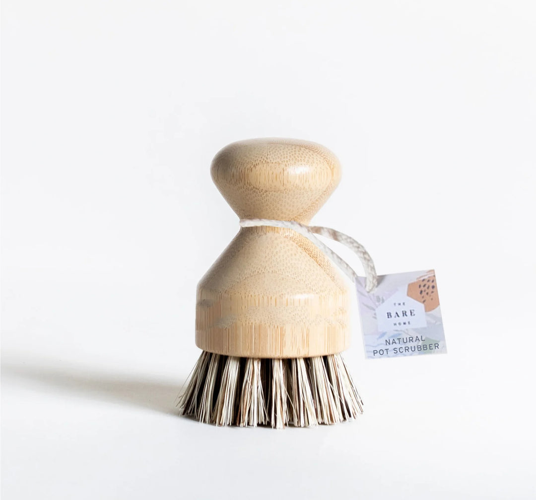 Natural dish scrubber brush from The Bare Home with durable bristles and wooden handle for effective kitchen cleaning.
