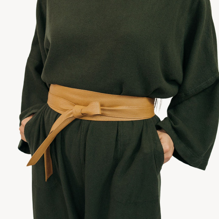 Pokoloko Obi leather wrap belt featuring a sleek, natural brown leather strap with a simple, stylish design.