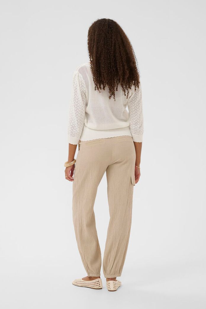 Cream Oluki patterned knit cardigan with a cozy, stylish design featuring floral knit  patterns and a front button closure.