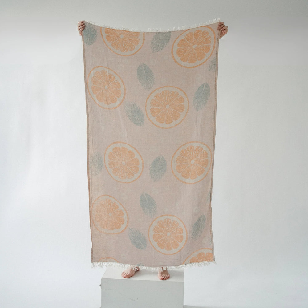 Orange Leaf Turkish cotton towel by Pokoloko with vibrant leaf pattern, soft texture, and plush, absorbent fabric for beach or bath use.