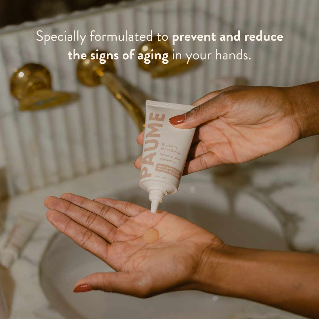 Hand applyingPaume anti aging hand serum with text about anti-aging benefits in a bathroom setting