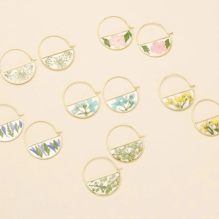 Scout pressed flower hoop earring featuring a delicate floral design on a circular hoop for a stylish, nature-inspired accessory.