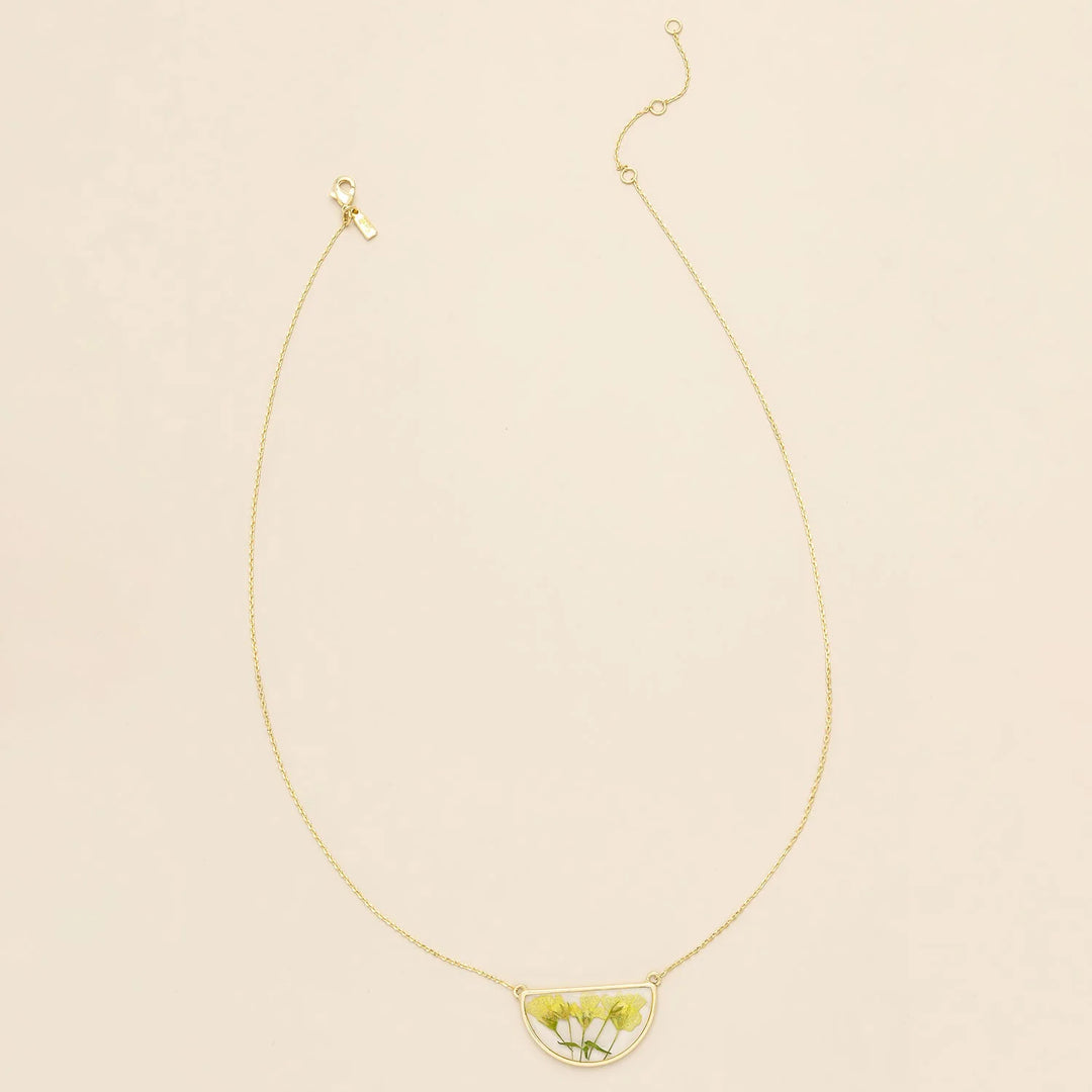 Pressed flower necklace by Scout featuring a delicate round  pendant with preserved colorful flowers on a fine chain.