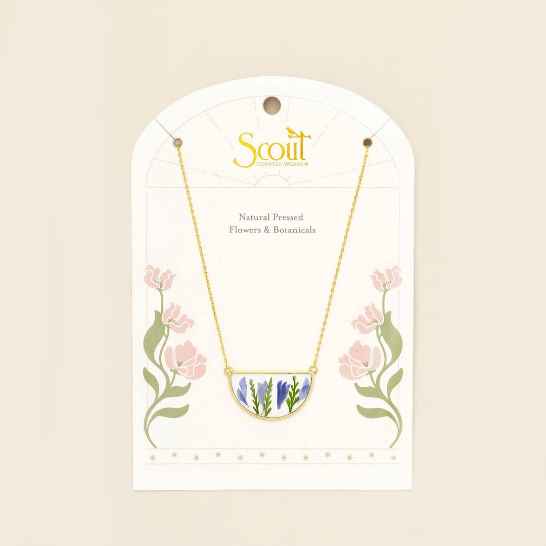 Scout pressed flower necklace featuring a delicate round pendant with real pressed flowers on a gold chain.