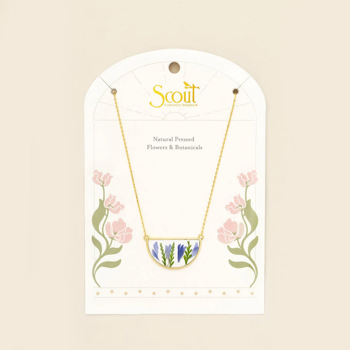 Scout pressed flower necklace featuring a delicate round pendant with real pressed flowers on a gold chain.