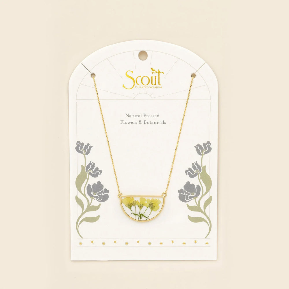 Scout pressed flower necklace featuring a delicate half circle pendant with preserved colorful flowers on a silver chain.