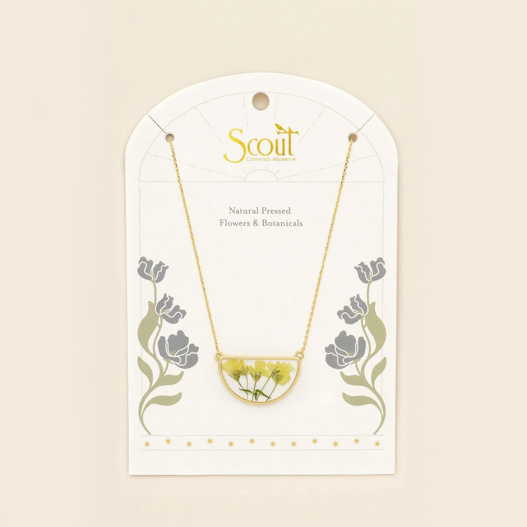 Scout pressed flower necklace featuring a delicate half circle pendant with preserved colorful flowers on a silver chain.