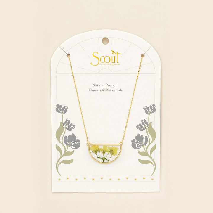 Scout pressed flower necklace featuring a delicate half circle pendant with preserved colorful flowers on a silver chain.