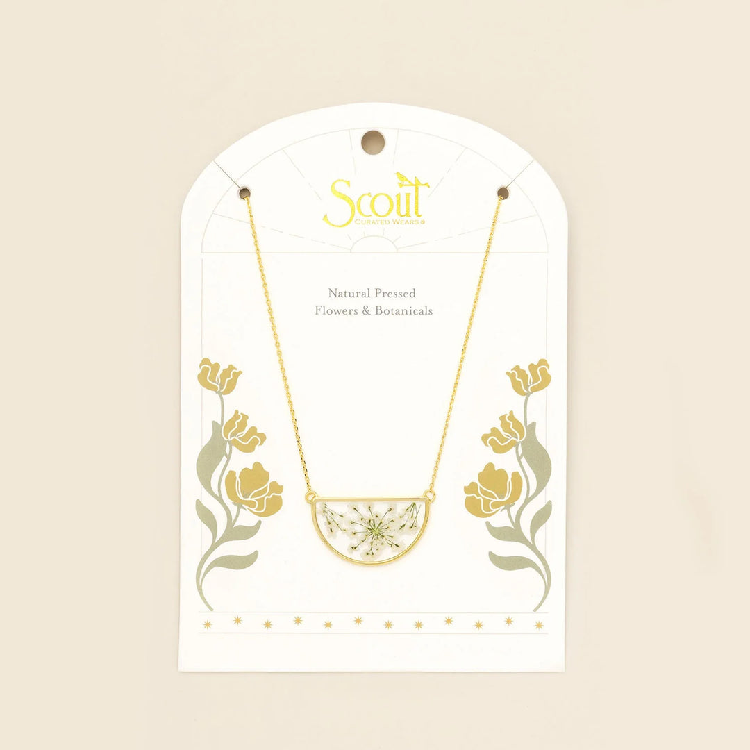 Scout pressed flower necklace featuring a delicate round pendant with preserved colorful flowers on a gold chain.