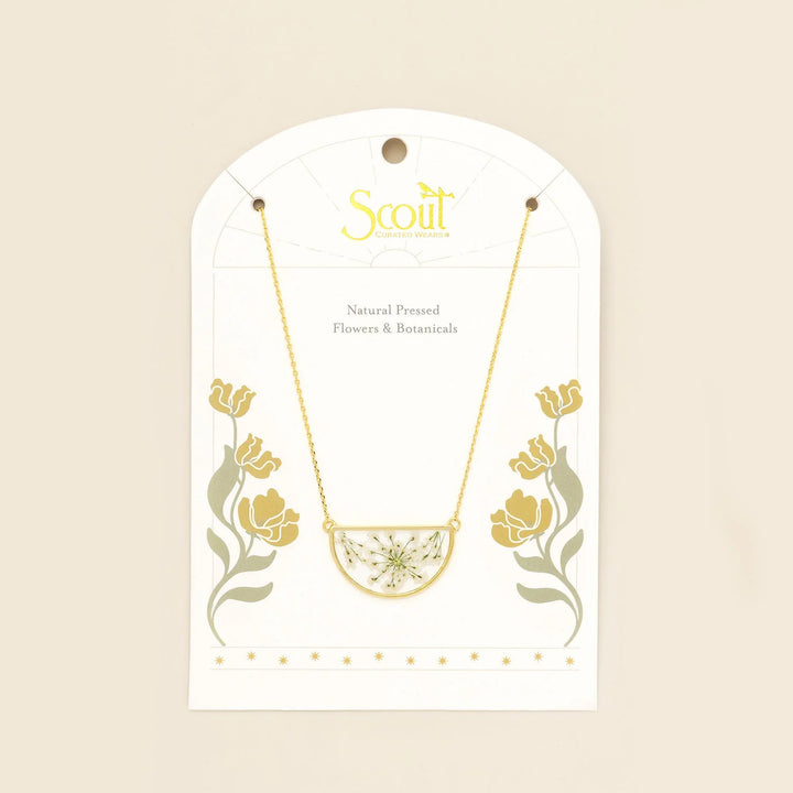 Scout pressed flower necklace featuring a delicate round pendant with preserved colorful flowers on a gold chain.