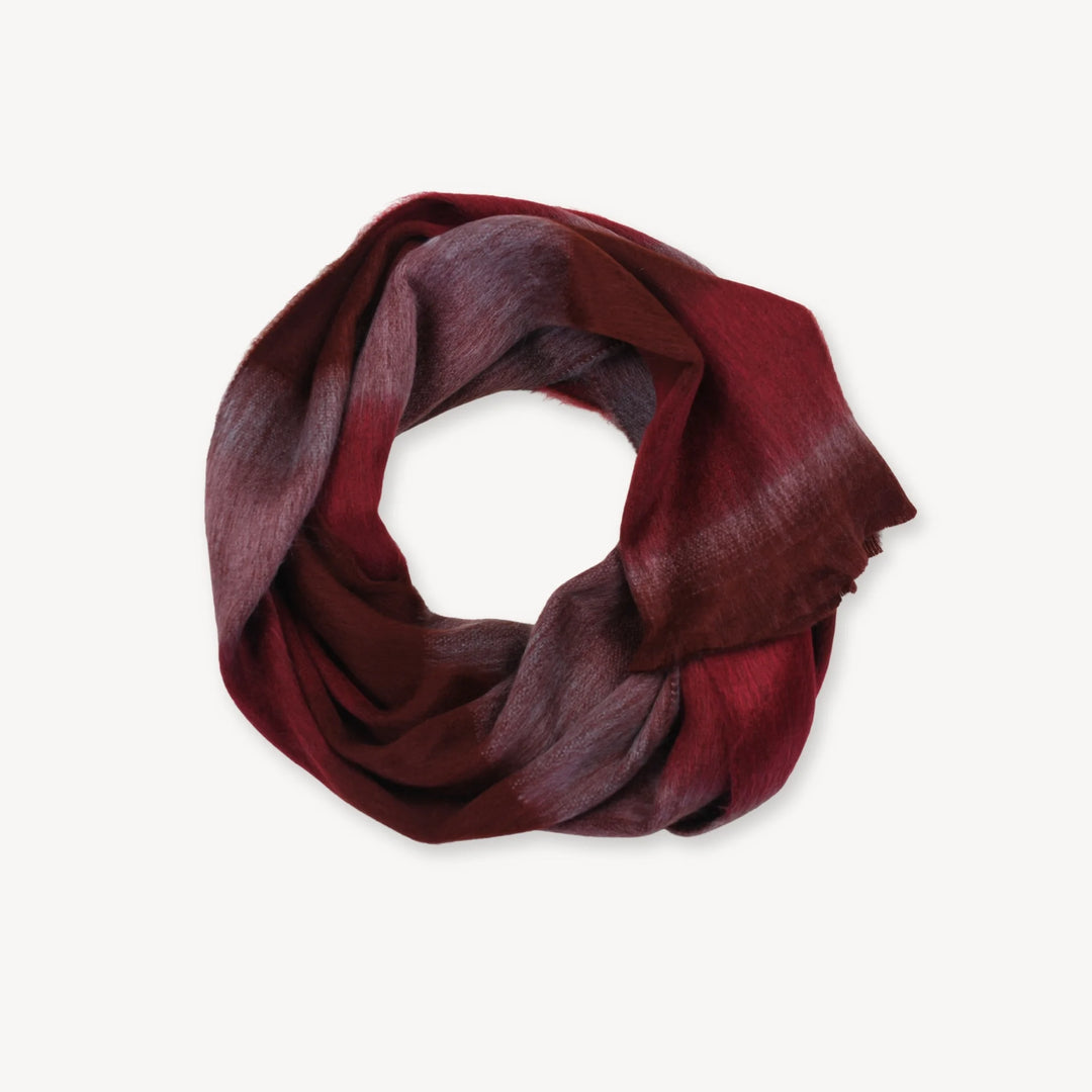 Red and burgundy gradient alpaca wool scarf on a white background
