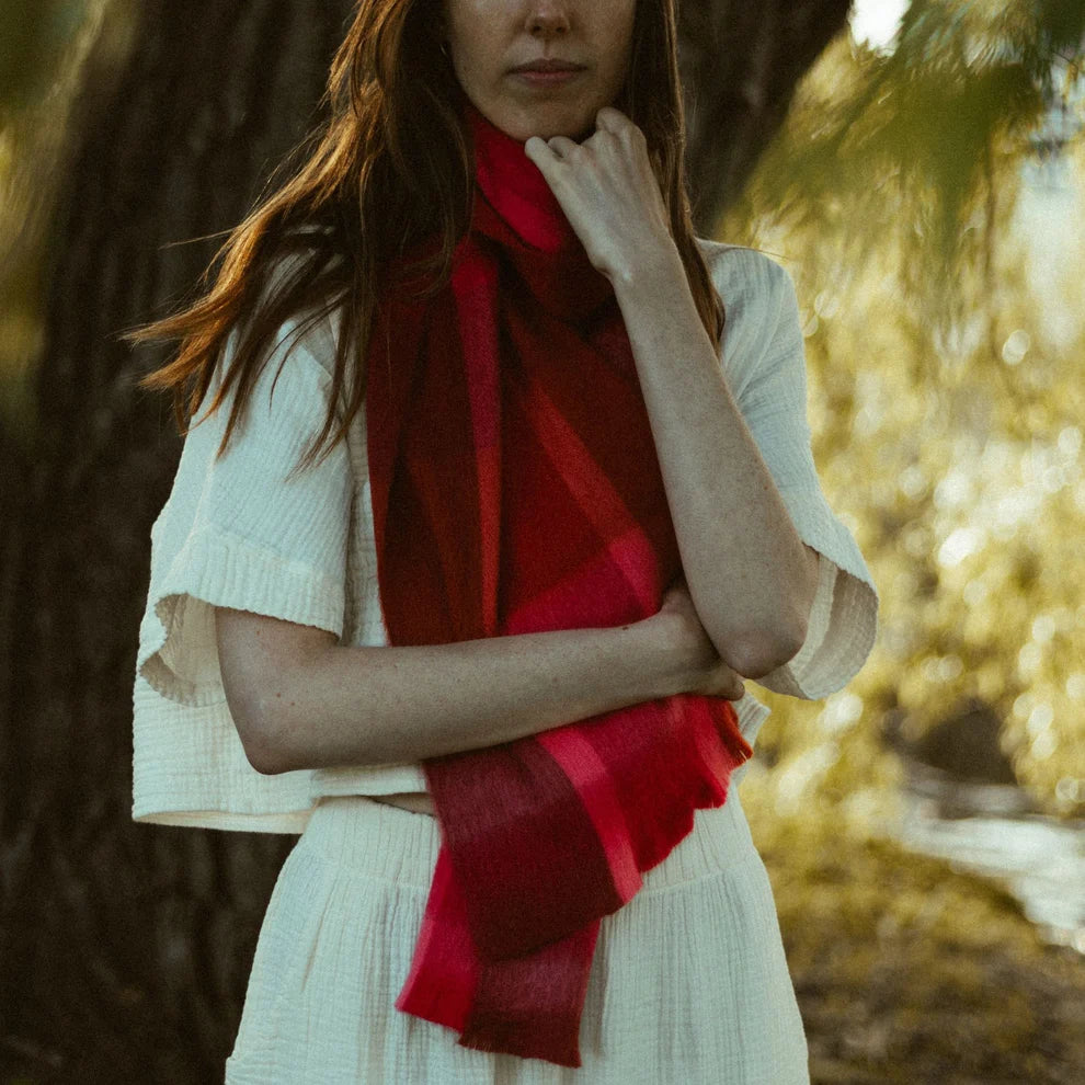 Woman wearing a red scarf in a forest setting