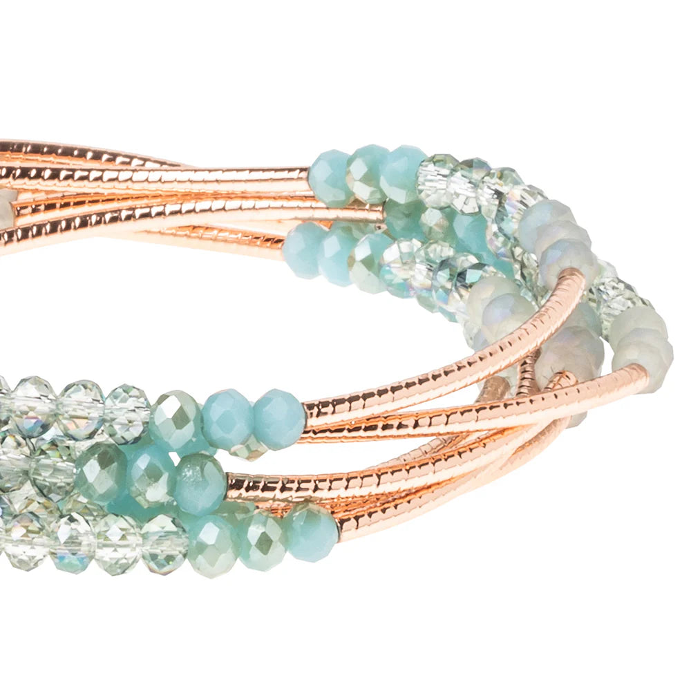 Scout Curated Wears Neptune Rose Gold Wrap Bracelet with intricate design, showcased on a neutral background.