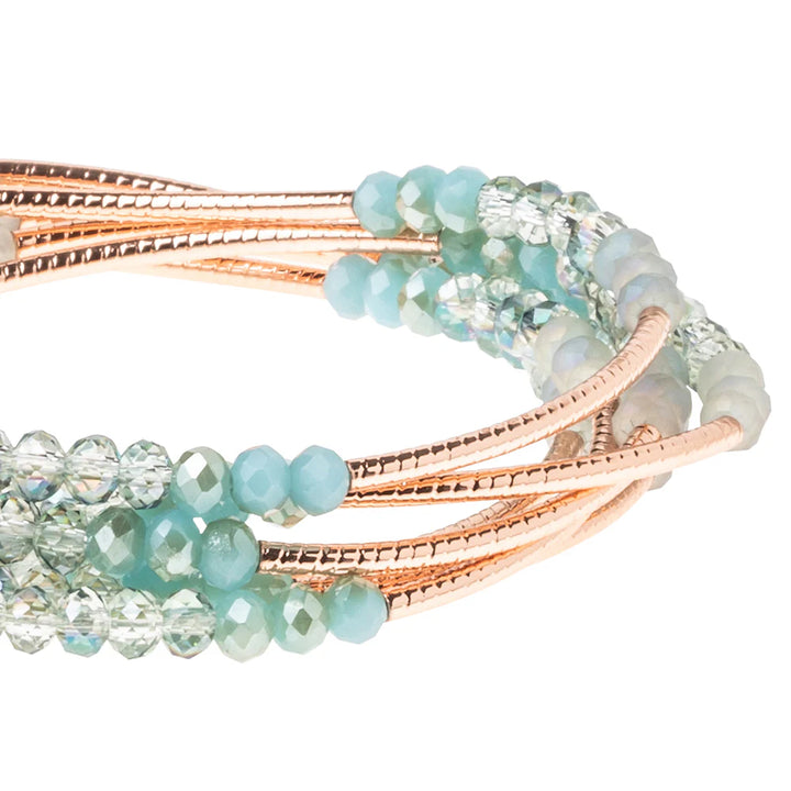 Scout Curated Wears Neptune Rose Gold Wrap Bracelet with intricate design, showcased on a neutral background.
