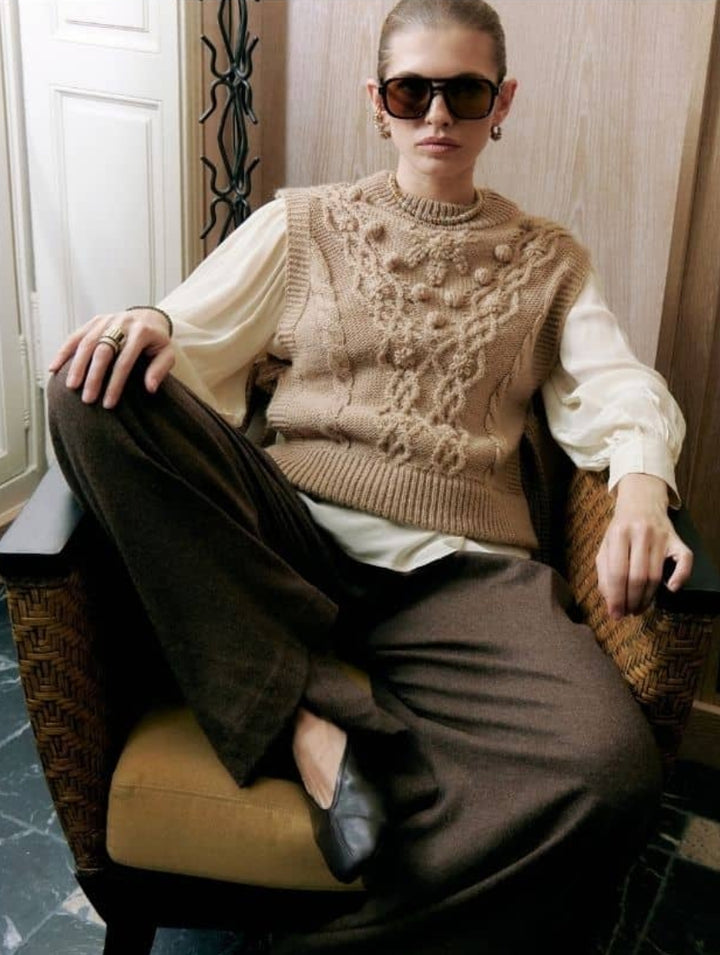 Louizon Noyamo knit sweater vest featuring a cozy, textured design in neutral tones, perfect for layered fall outfits.