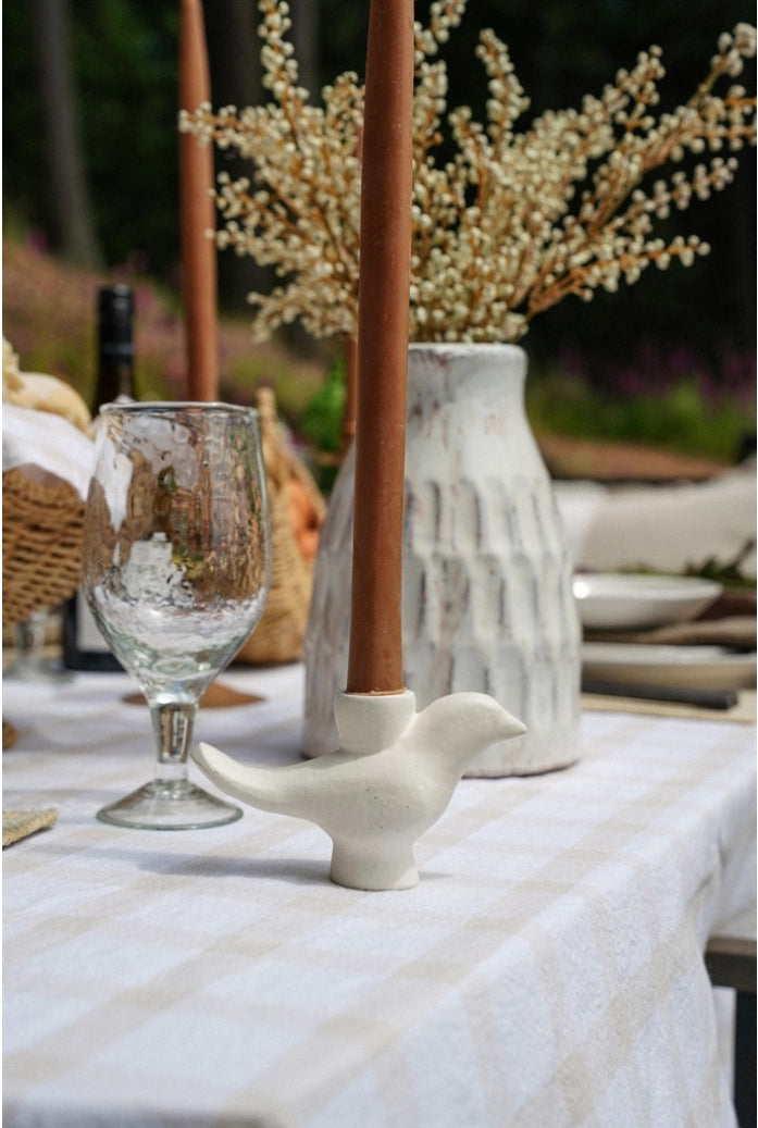 Indaba Wren candle holder with intricate metal bird design, perfect for holding a small pillar or tea light candle.