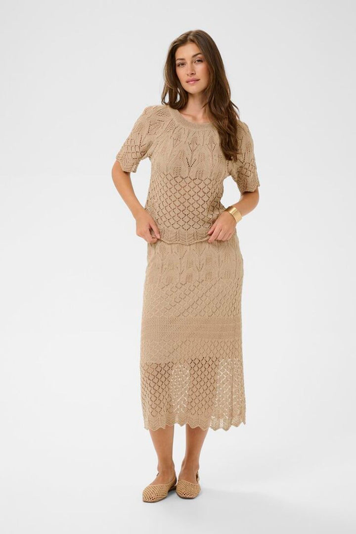 Cream Sevija knit short sleeve top featuring a snug fit, soft fabric, and stylish design ideal for casual or office wear for summer .