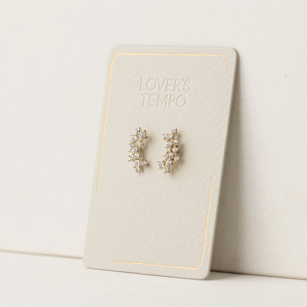 Pair of crystal climber earrings on a 'Lover's Tempo' branded card against a light background
