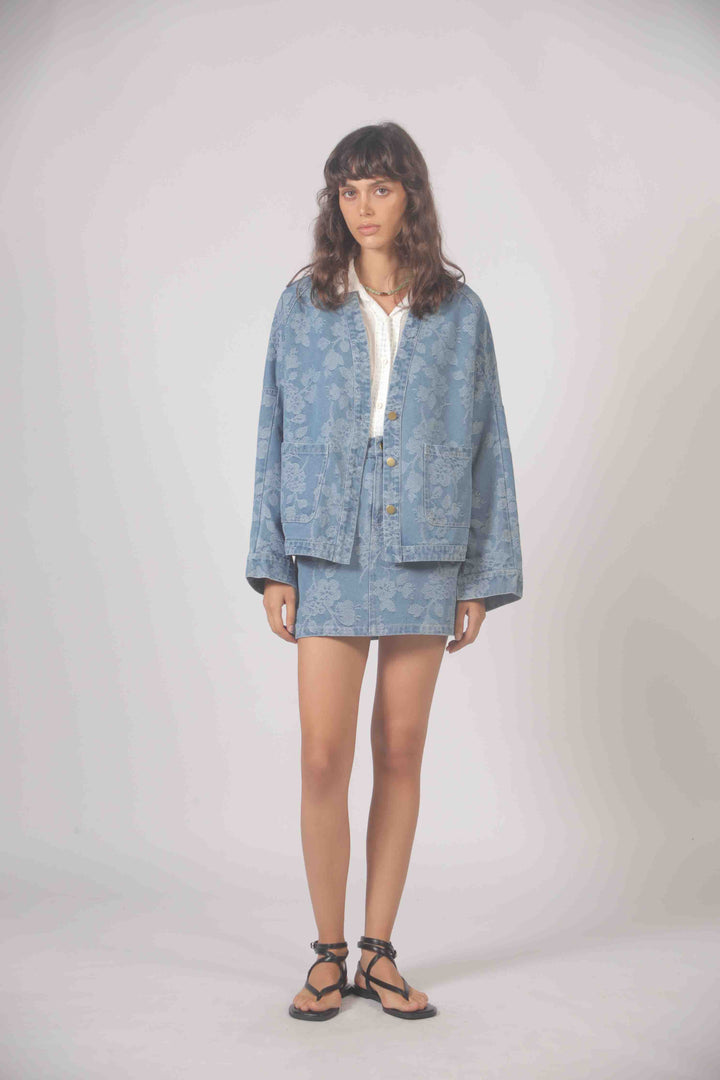 Freeflower embroidered denim jacket by The Korner featuring detailed floral embroidery on classic blue denim.